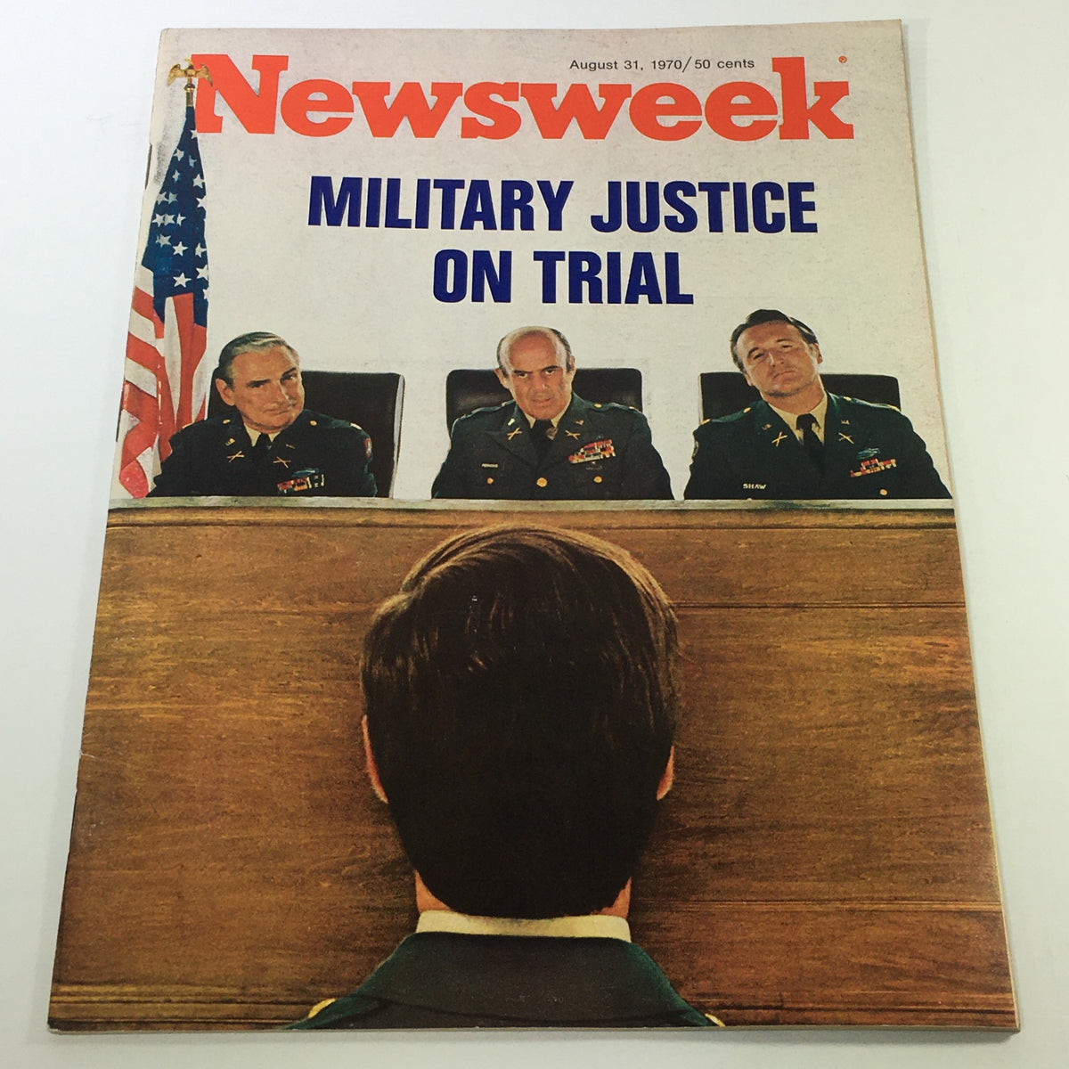 Cover of Newsweek Magazine from August 31, 1970, featuring the title 'Military Justice On Trial'. The image depicts three military officials seated at a trial with a focus on the back of a young man facing them. This vintage magazine captures historical discussions on military law during a pivotal time in U.S. history.