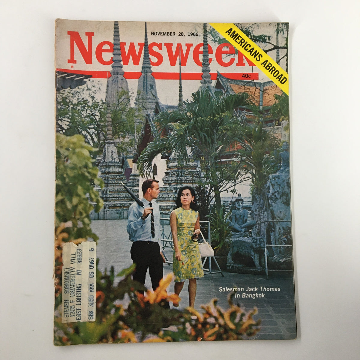 Cover of the Newsweek magazine dated November 28, 1966, featuring salesman Jack Thomas in Bangkok. The image showcases a scene with a man and a woman walking amidst tropical foliage, with ornate temple structures in the background, capturing the essence of 1960s culture.
