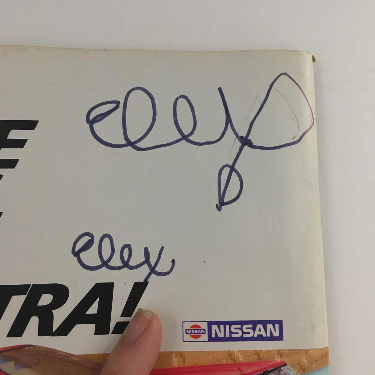 Back cover of Car and Driver Magazine May 1986 showing doodles and a Nissan logo, adding a unique touch to this vintage automotive publication.
