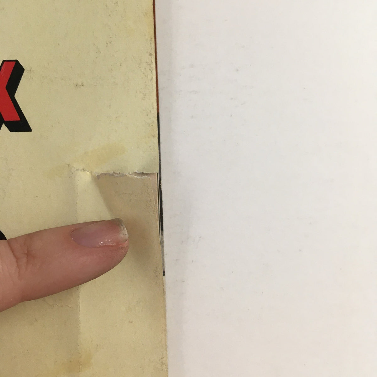 Close-up of the corner of the October 1973 Car and Driver Magazine showing minor wear and a small tear near the edge, preserving the history of automotive publications.