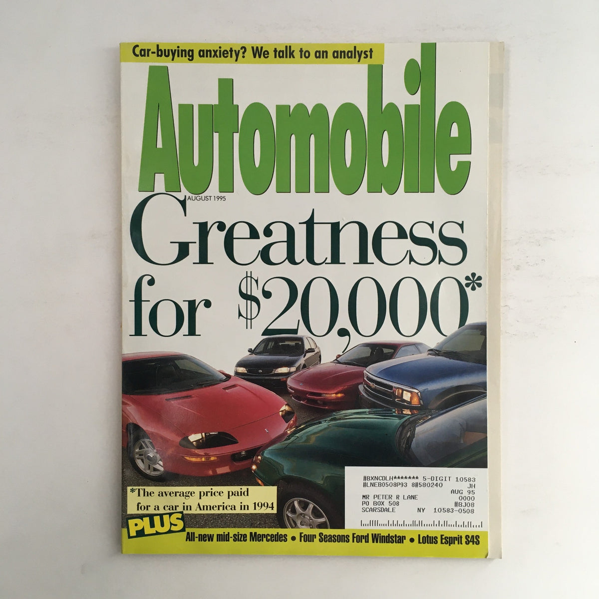 Automobile Magazine August 1995 cover featuring the title 'Greatness for $20,000', showcasing various cars including a Ford Windstar and a Lotus Esprit S4S, highlighting automotive trends of the 1990s.