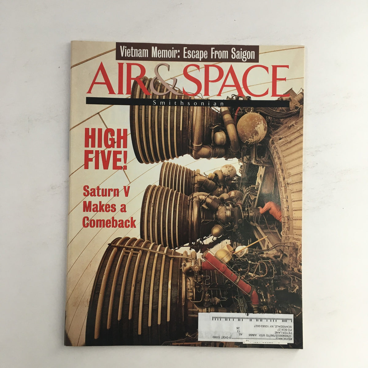 Cover of Air & Space Magazine 1996 titled 'Saturn V Makes a Comeback & Vietnam Memoir,' featuring detailed images of rocket engines with text highlighting the Saturn V's significance and a Vietnam memoir.