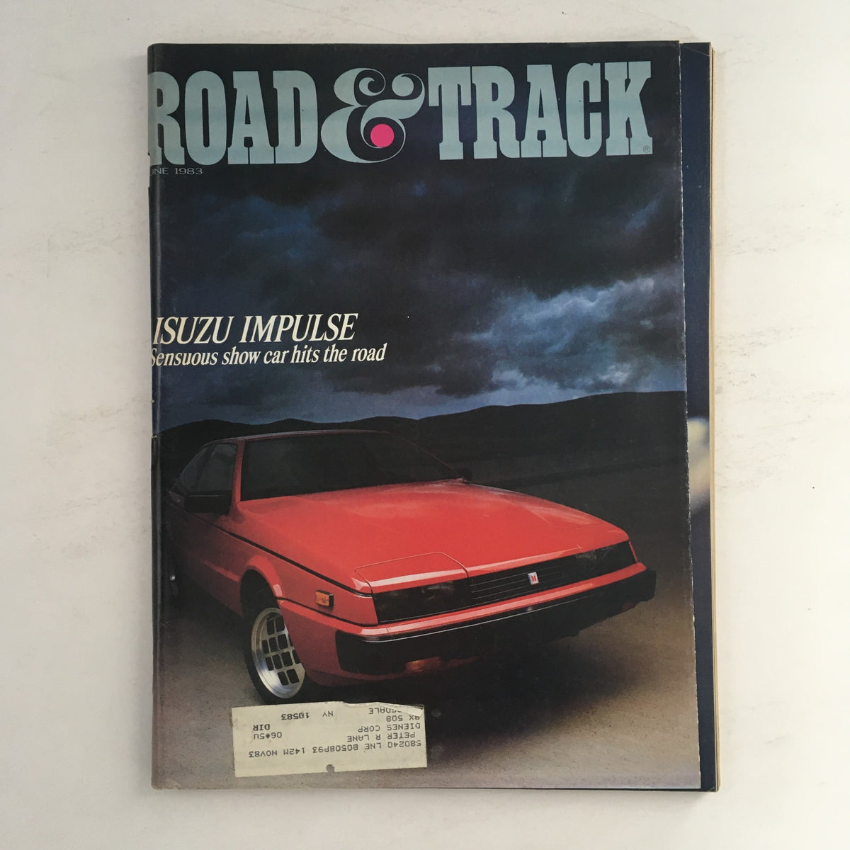 Road & Track Magazine June 1983 cover featuring the Isuzu Impulse, described as a sensuous show car. The magazine highlights automotive design from the 1980s.