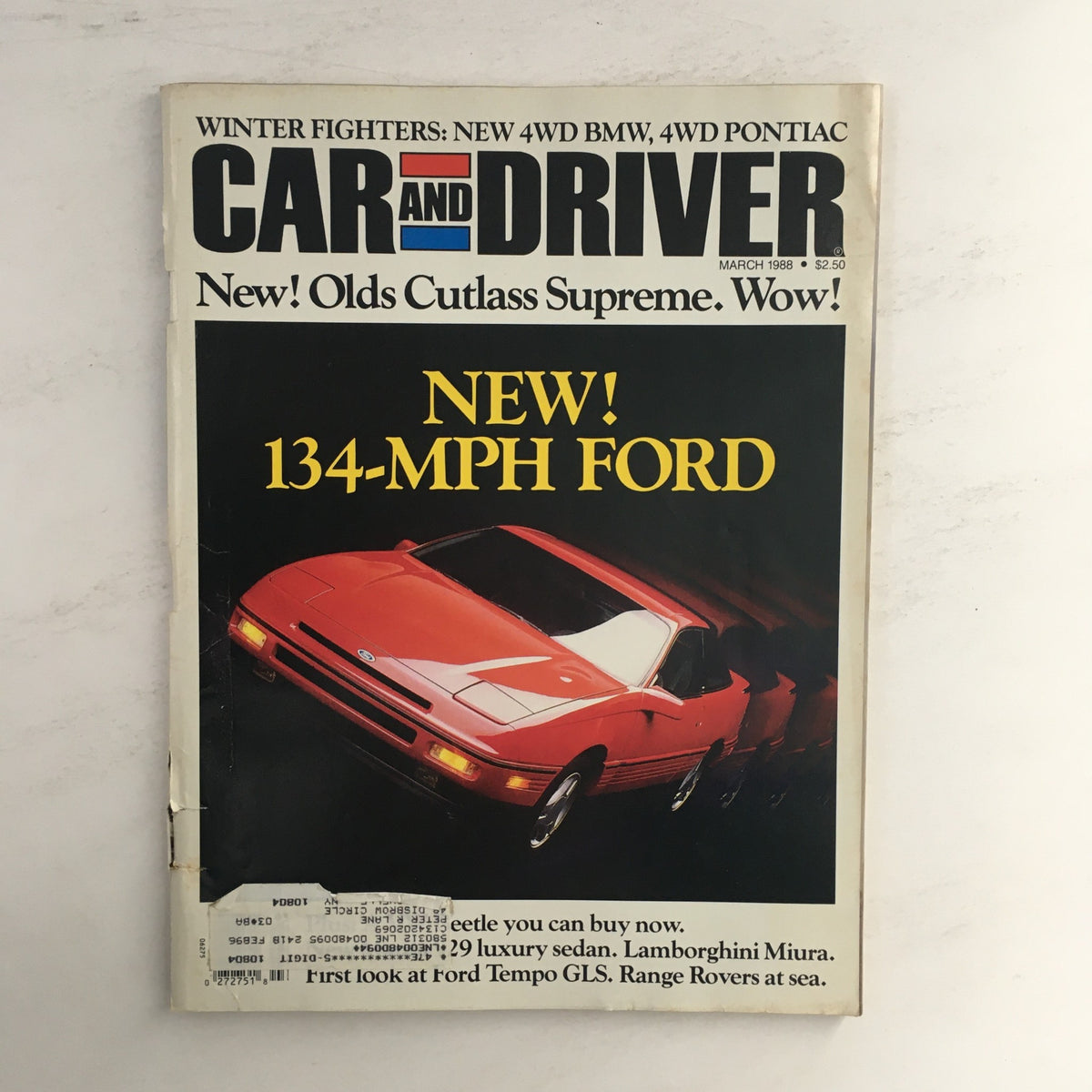 Car and Driver Magazine March 1988 cover featuring Olds Cutlass Supreme and Ford Tempo GLS with a striking graphic design and automotive photography.