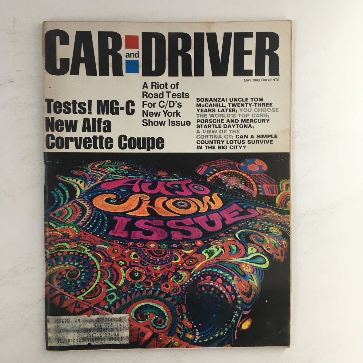 Cover of Car and Driver Magazine May 1968 featuring tests of MG-C, new Alfa, and Corvette Coupe, with vibrant psychedelic design elements.
