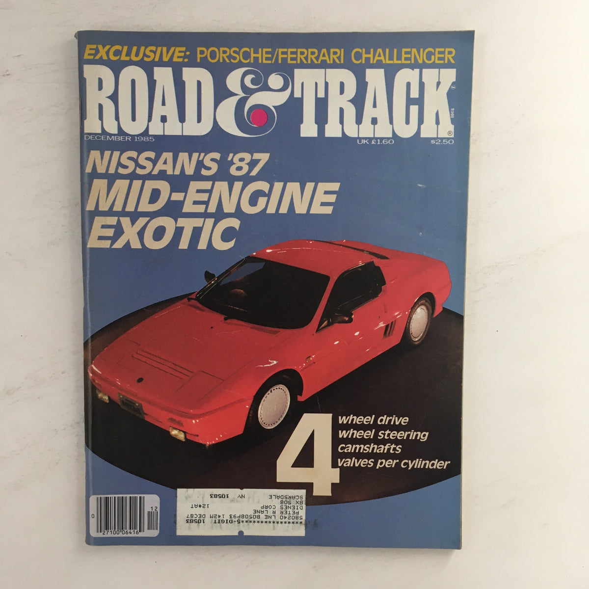 Cover of Road & Track Magazine December 1985 featuring Nissan's '87 Mid-Engine Exotic with a red sports car on display, headlines about Porsche and Ferrari, emphasizing automotive excellence in the 1980s.