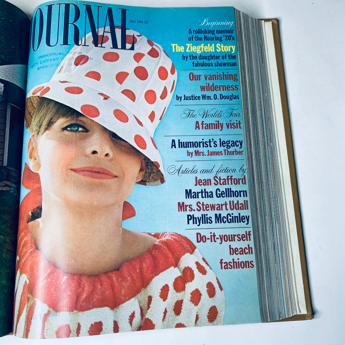 Cover of Ladies' Home Journal July 1964 featuring a woman in a polka dot hat and dress, emphasizing vacation styles and humorous articles for summer reading.
