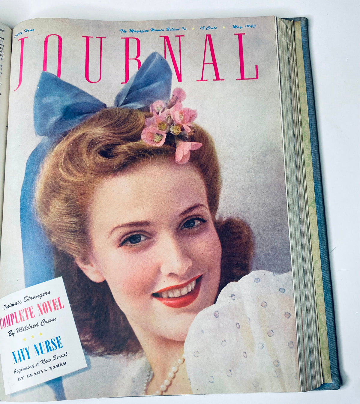 Ladies' Home Journal Library Bound Magazine 1943 Full Year January - December, May 1943 cover showcasing a woman with a blue bow and floral hair decoration.