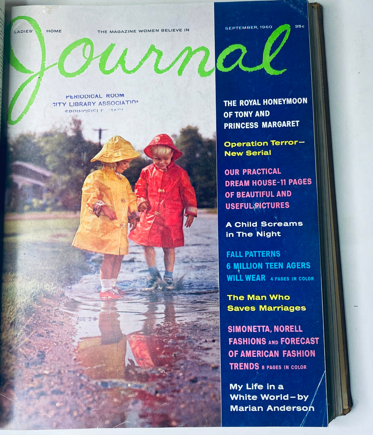 Ladies' Home Journal Library Bound Magazine 1960 - Cover of the September 1960 issue, showcasing two children in colorful raincoats standing in a puddle.