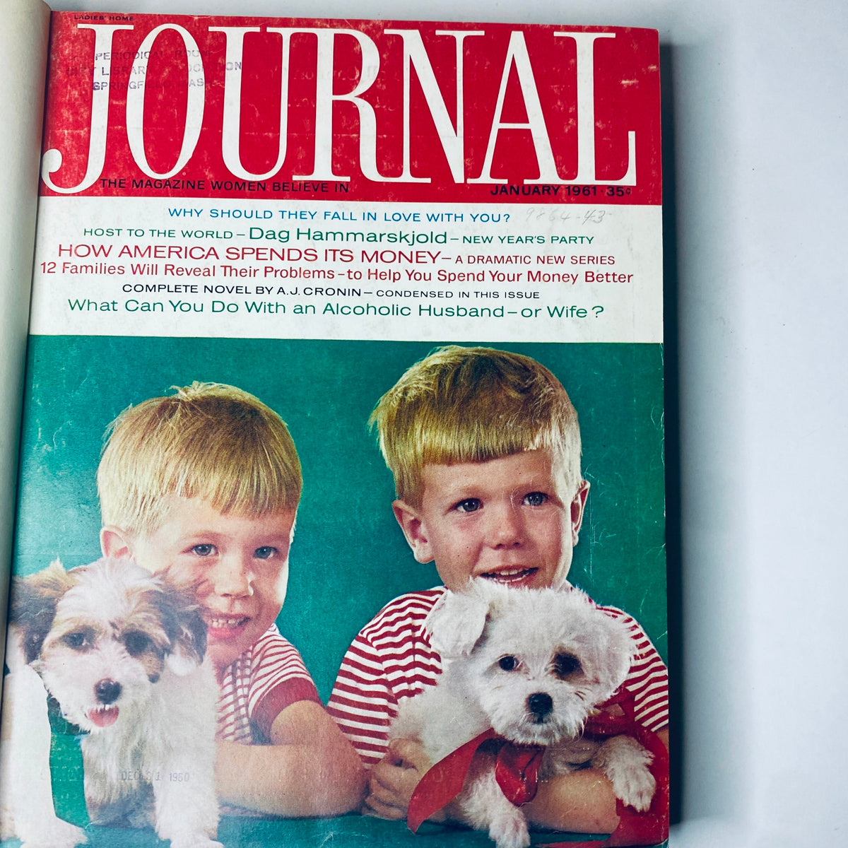 Cover of Ladies' Home Journal Bound Magazine 1961 featuring two boys with puppy dogs in January issue, highlighting articles about family and financial advice.