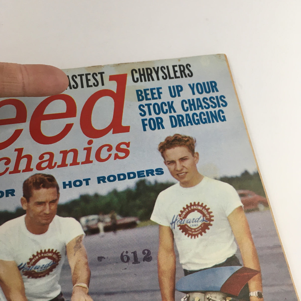 Close-up of the cover of Speed Mechanics Magazine August 1962, showcasing the title and the two men in racing attire next to a drag racing vehicle.