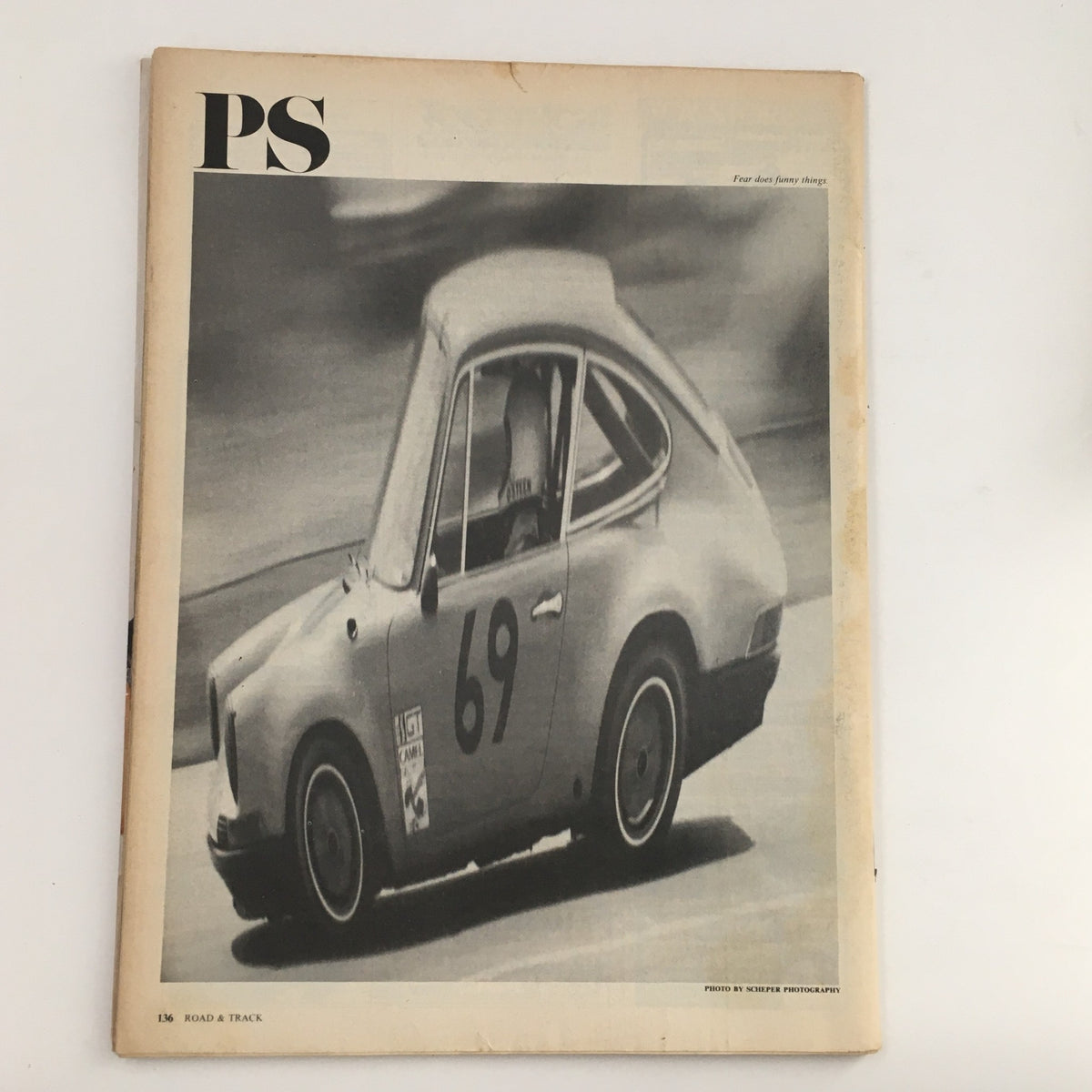 Interior page of Road & Track Magazine February 1977, featuring PS section with a black-and-white image of a classic racing car, complementing the automotive focus of the magazine.