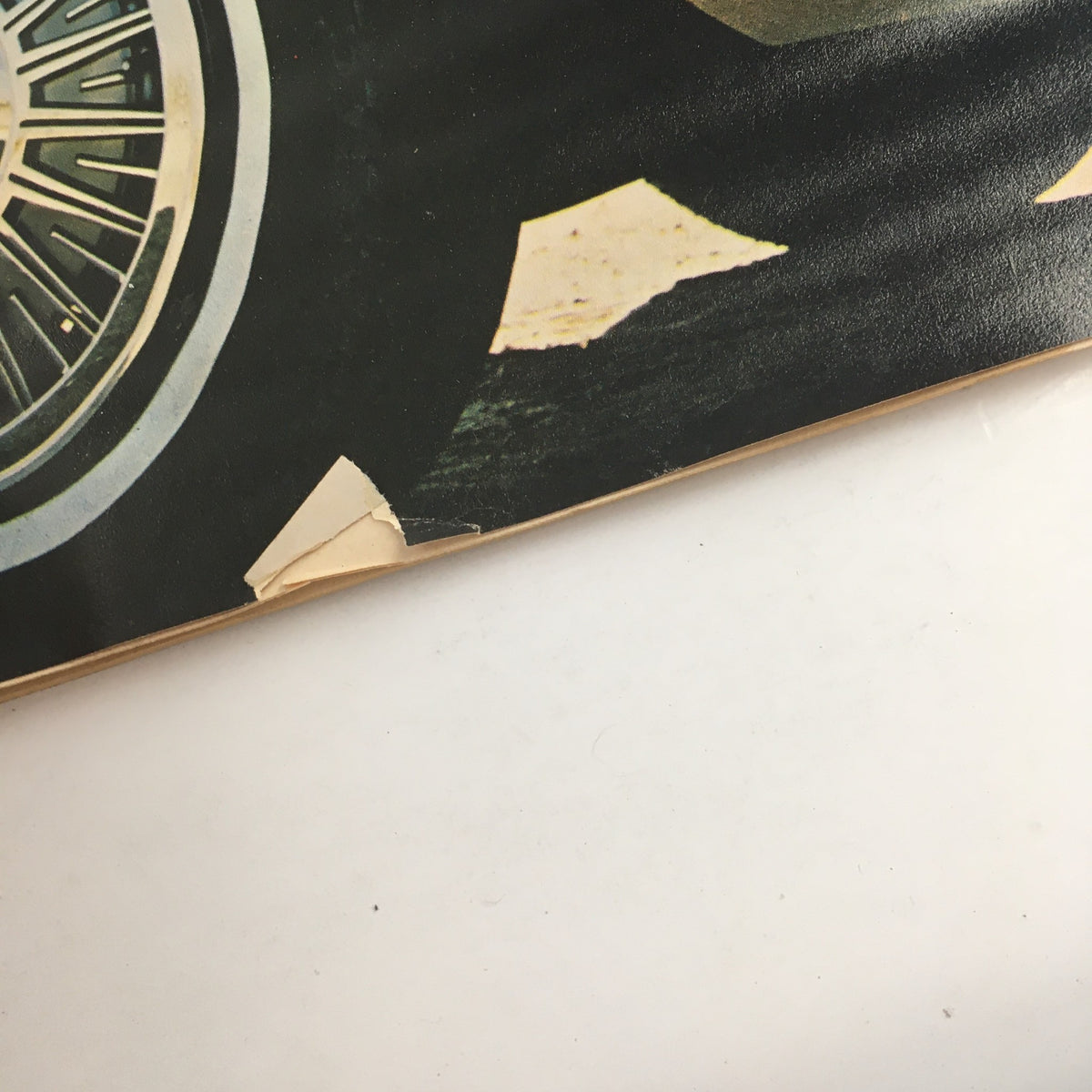 Close-up detail of the vintage automobile wheel from the cover of Consumer Reports Magazine April 1981 Annual Auto Issue, showcasing wear typical for its age.