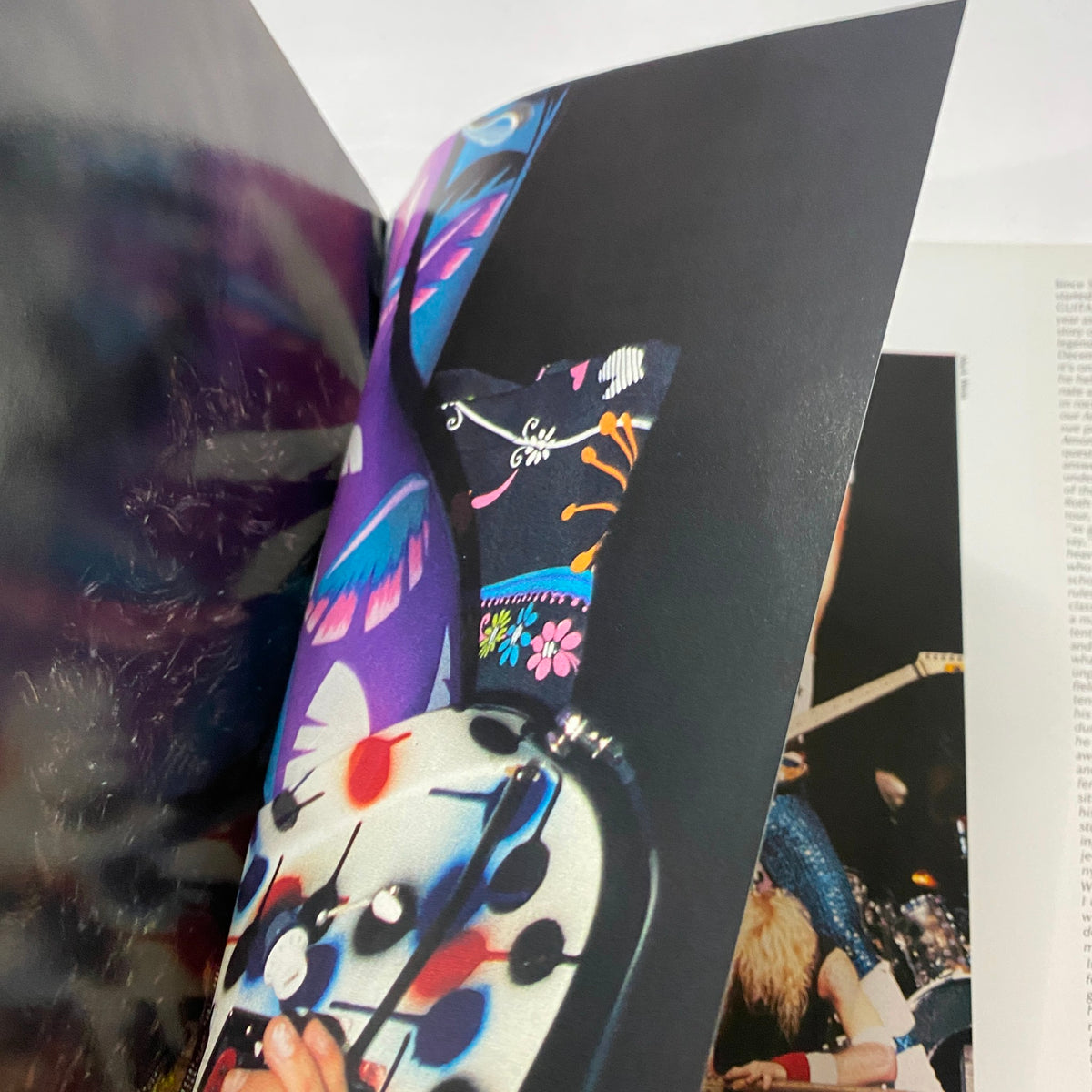 Inside spread of the Guitar for the Practicing Musician Magazine November 1987 showing colorful imagery related to Mötley Crüe and the glam rock era, highlighting the band's iconic style.