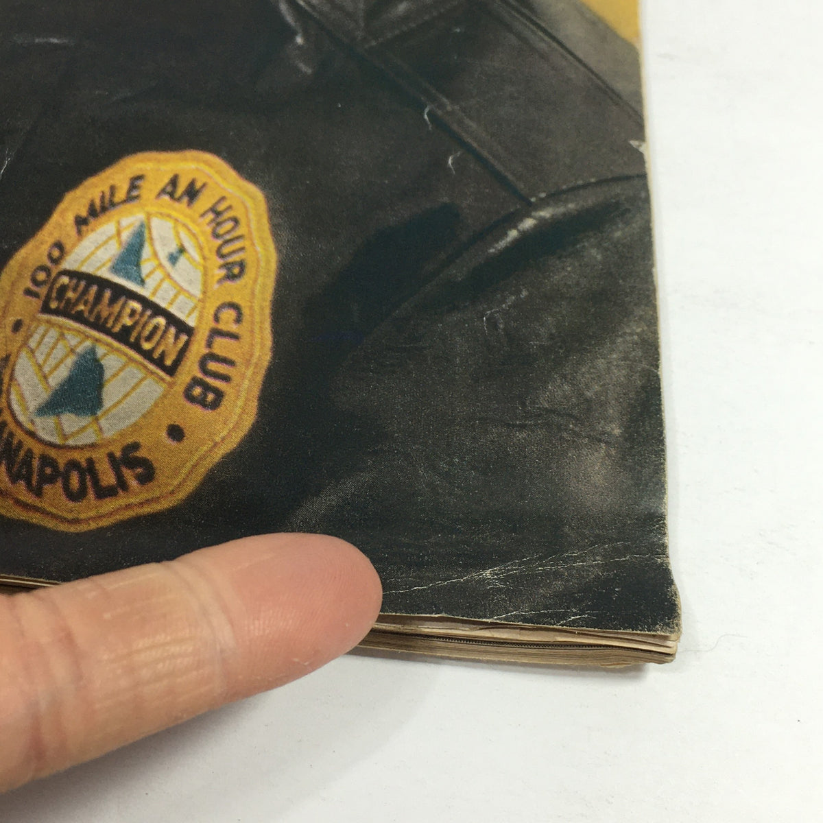 Close-up of the original cover of the Sports Illustrated Magazine from May 26, 1958, featuring the 100 Mile An Hour Club patch, related to Anton 'Tony' Hulman Jr., an influential figure in American motorsports.