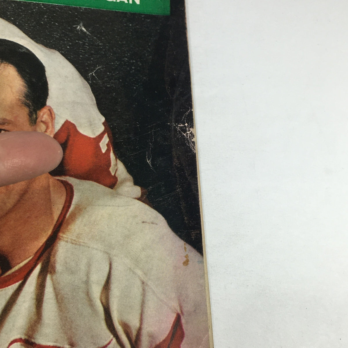 Close-up of a section from the VTG Sports Illustrated Magazine March 18, 1957, showcasing part of the cover that likely features a hockey player, emphasizing its vintage appeal.