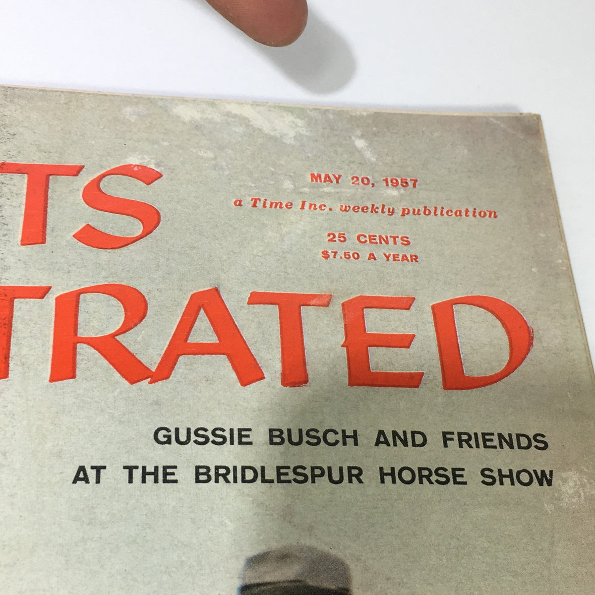 Close-up of the cover of Sports Illustrated Magazine dated May 20, 1957, featuring the title prominently and highlighting Gussie Busch and friends at the Bridlespur Horse Show.