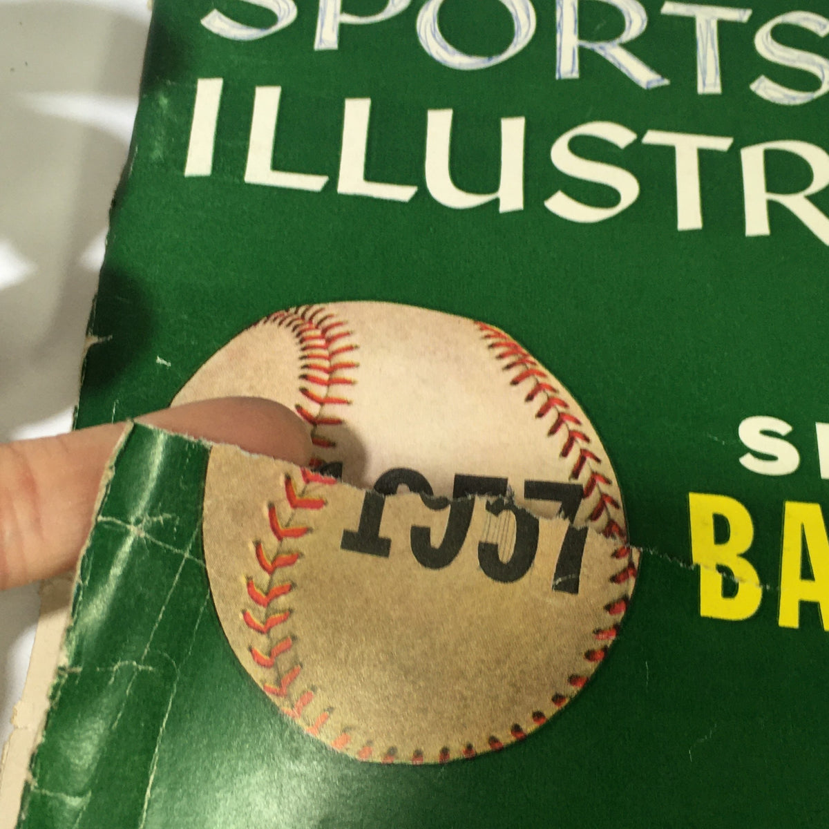 Detail of the corner of the VTG Sports Illustrated Magazine April 15 1957 - Special Baseball Issue featuring a baseball graphic and the year 1957.