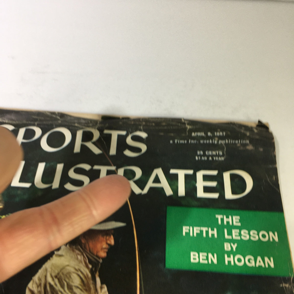 Another close-up view of the Sports Illustrated magazine from April 8, 1957, highlighting the title 'The 5th Lesson by Ben Hogan', with a focus on the aged cover.