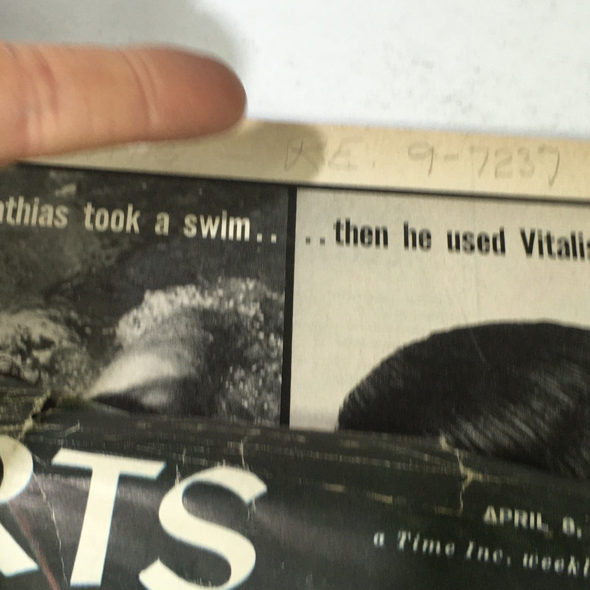 Close-up of the Sports Illustrated magazine from April 8, 1957, featuring text about Bob Mathias swimming. The magazine is in fair condition, showing wear with edges and corners having damage.