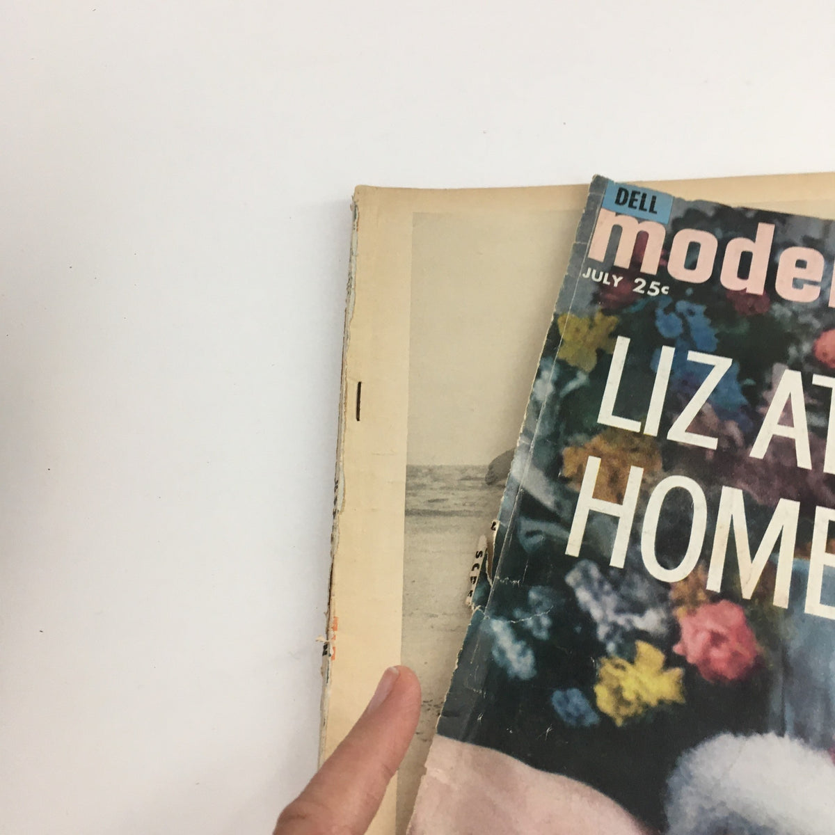 Interior view of Modern Screen Magazine from July 1961, showcasing the cover with Elizabeth Taylor and the contents of the magazine.