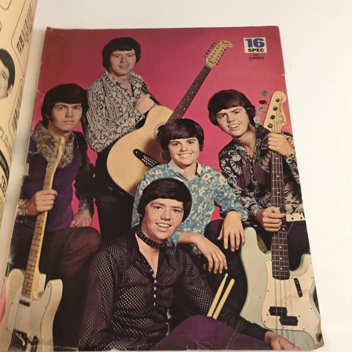Cover image of 16 Magazine December 1970 showcasing the Osmond brothers, featuring five siblings with guitars, dressed in vibrant 1970s fashion. A collector's item for pop culture enthusiasts.
