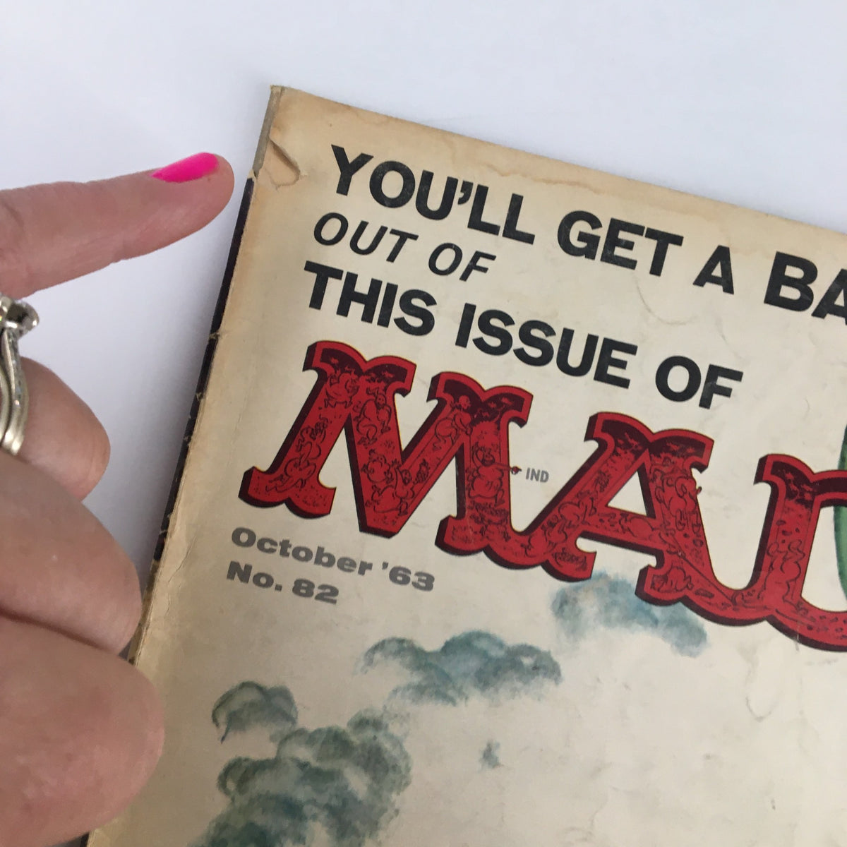 Close-up of Mad Magazine October 1963 No. 82 cover, highlighting the title "You'll Get A Bang" and detailing the vintage magazine's condition.