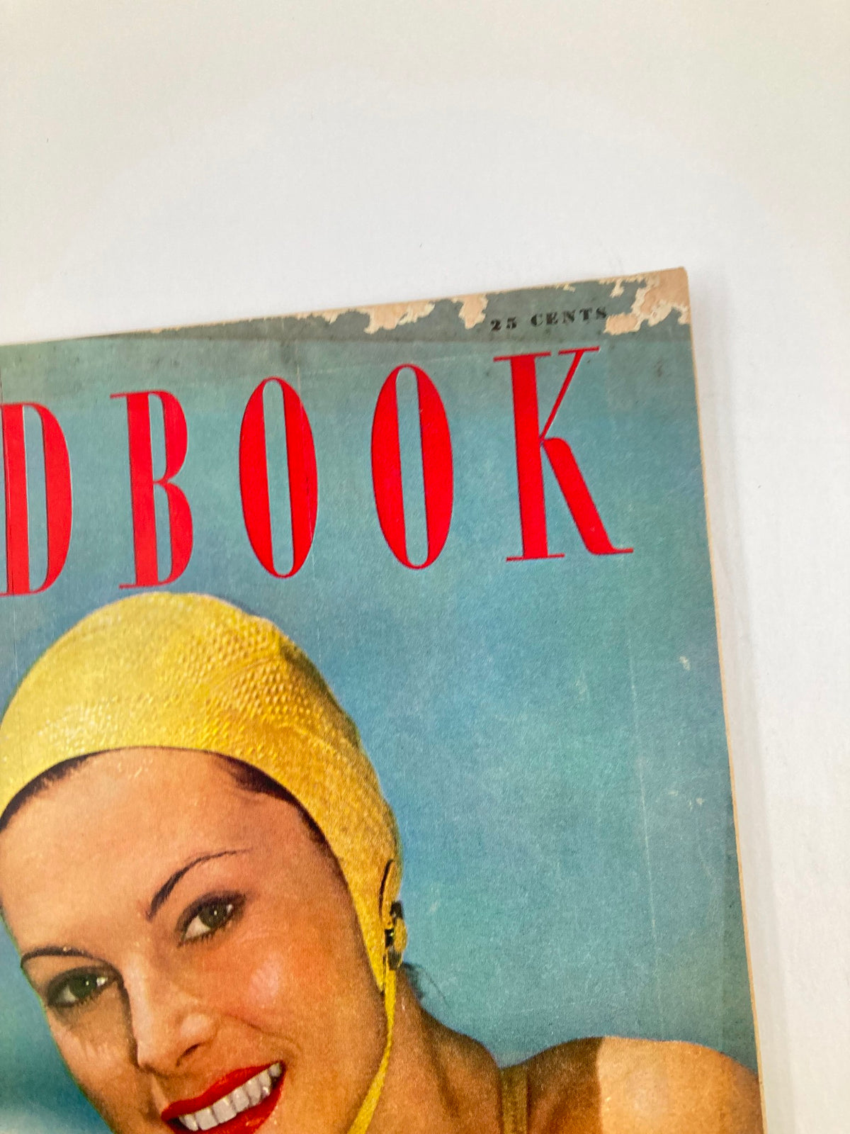 Side angle view of the VTG Redbook Magazine July 1949 Vol 93 #3 showcasing the cover design and a smiling woman in a yellow swim cap against a blue background.