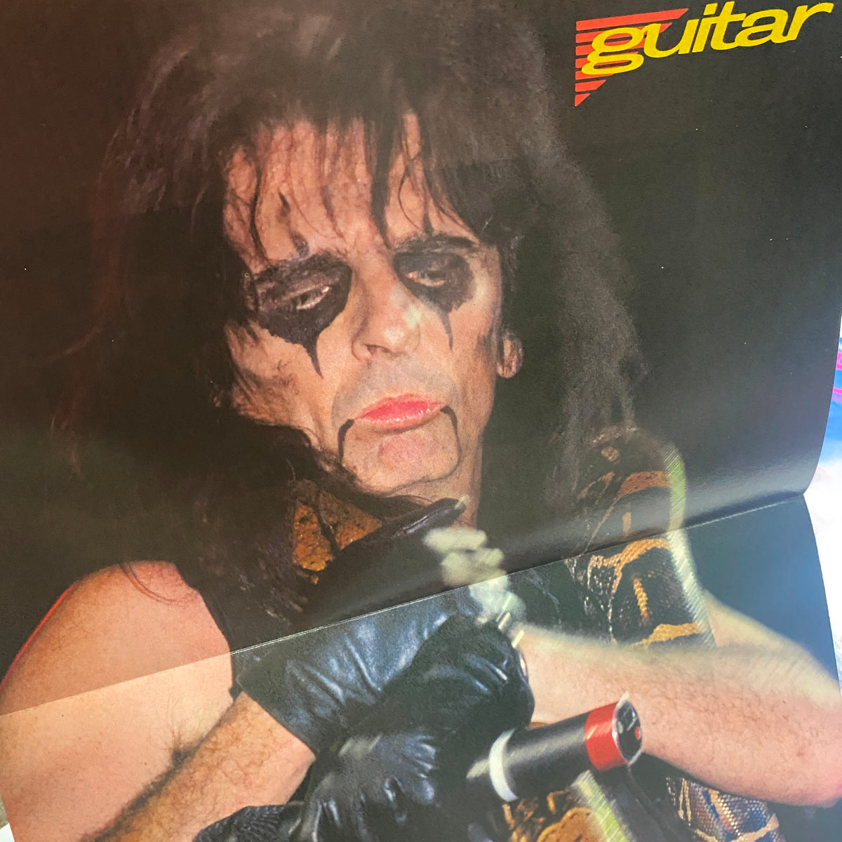 Fold-out poster featuring Alice Cooper from Guitar for the Practicing Musician Magazine February 1990, with a striking image of the rocker in makeup.