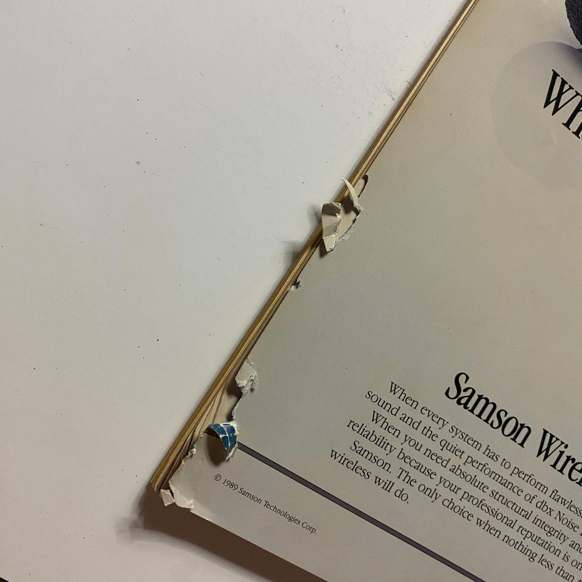 Close-up view of the bottom edge of the back cover of the Guitar for the Practicing Musician Magazine October 1989, showing wear and tear typical of vintage magazines, enhancing its collectible value.