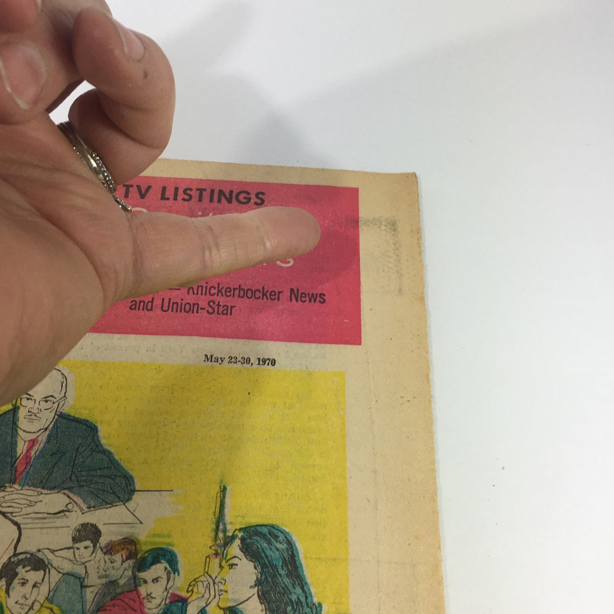 Close-up of VTG TV Week's Complete TV Listings May 23-30 1970 highlighting text and hand pointing at the title section.