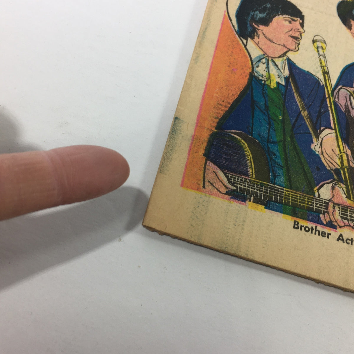 Close-up of Vintage TV Week magazine cover highlighting Brother Acts Back-to-Back, July 11-18, 1970, showing detailed illustrations and a finger emphasizing the design.