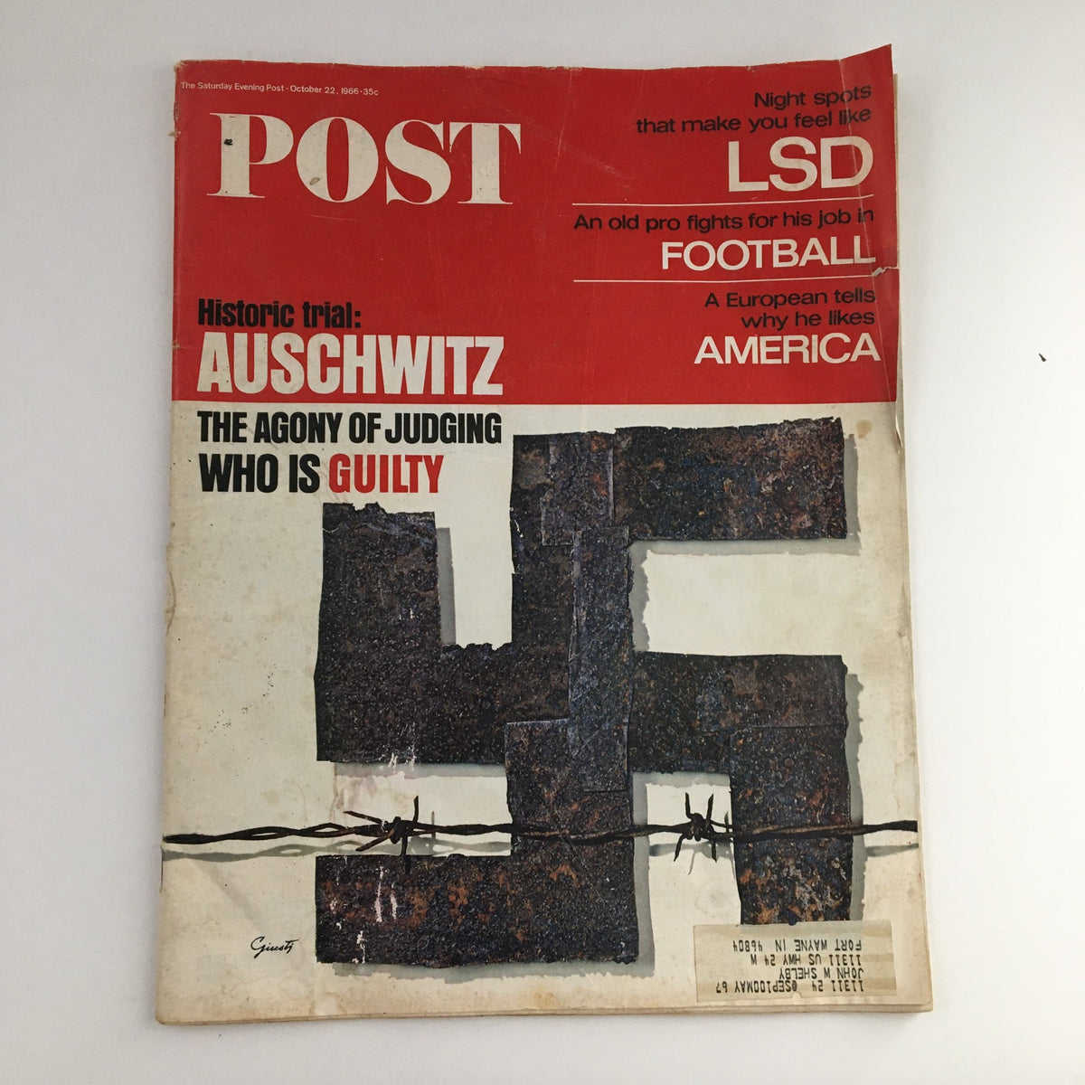 The Saturday Evening Post October 22 1966 magazine cover featuring the title 'Historic Trial: Auschwitz - The Agony of Judging Who is Guilty'. The cover showcases a striking image related to the Auschwitz camp, with a bold color scheme and text.