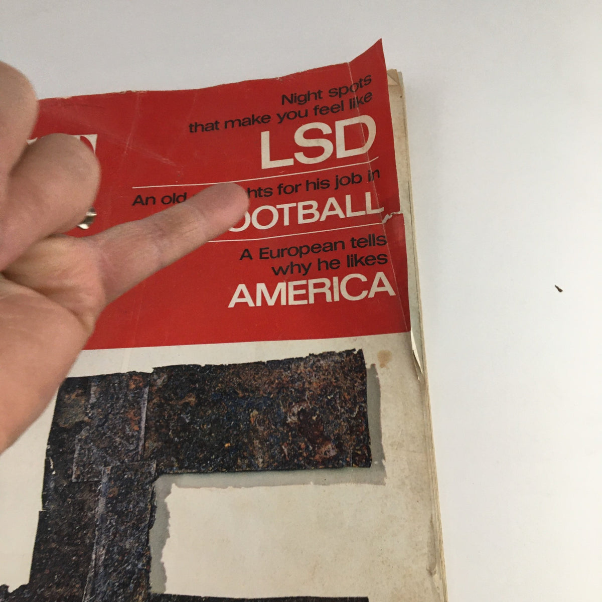 Cover detail of The Saturday Evening Post October 22 1966 featuring text on nightlife, LSD, and sports, with a close-up view of visible wear.