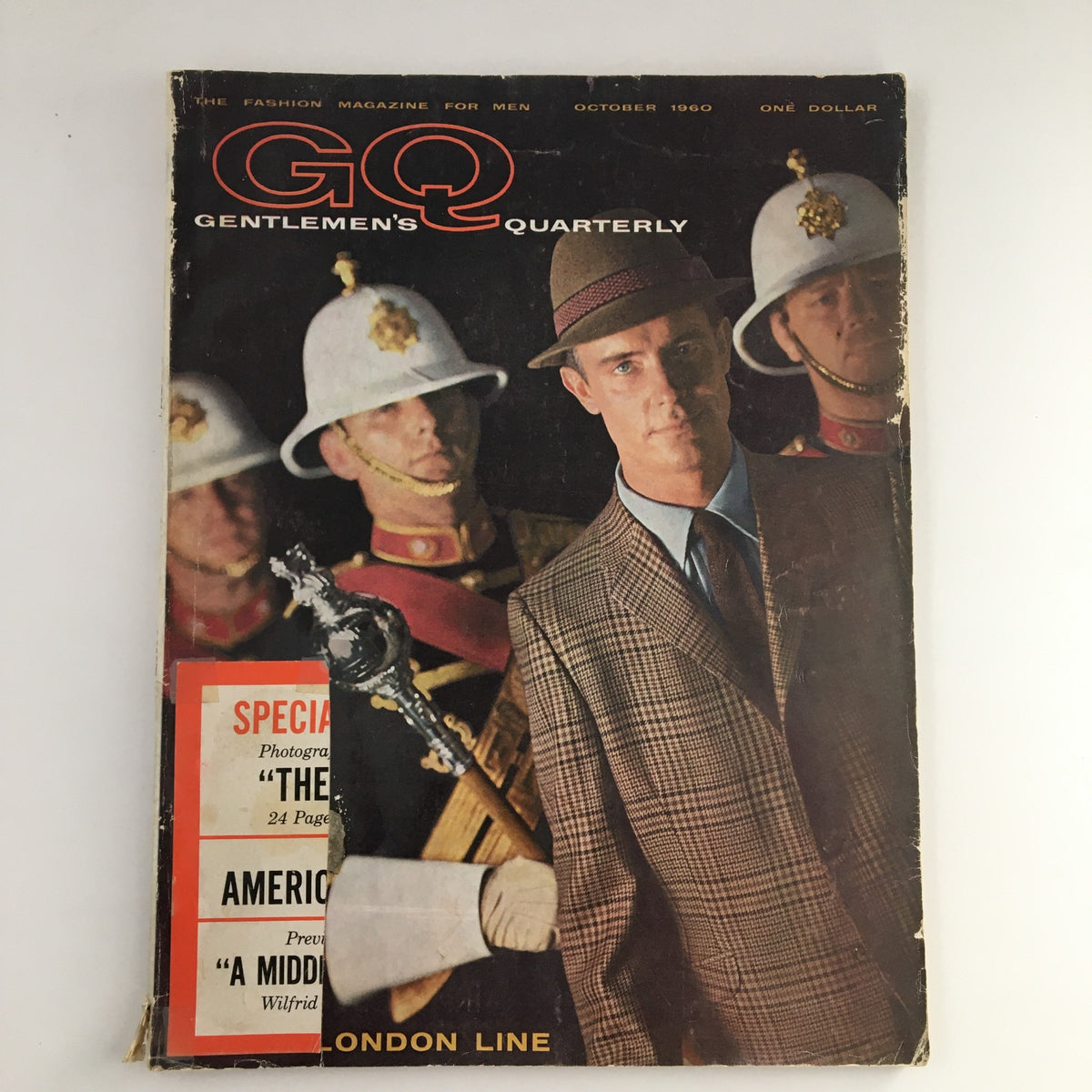 Cover of GQ Magazine October 1960 featuring The London Line with a stylish man in a plaid suit and British soldiers in the background.