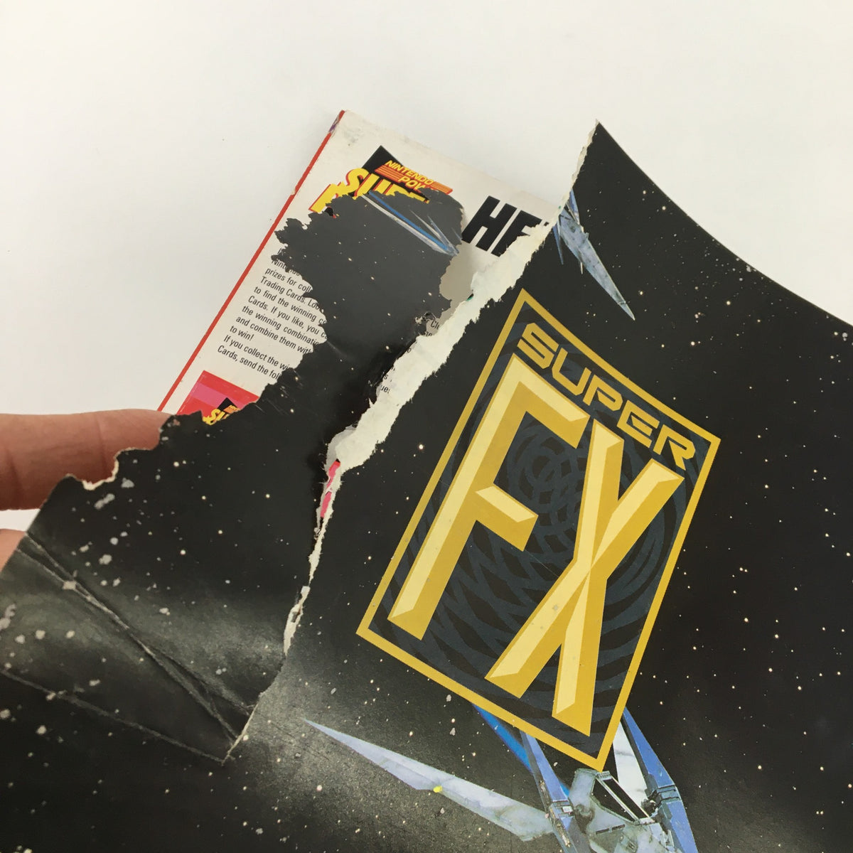 Damaged page from Nintendo Power Magazine March 1993 #46 featuring the Super FX logo and a science fiction design.