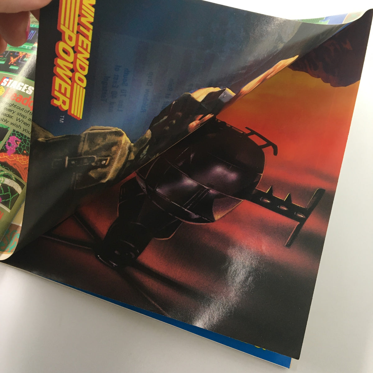 An image of a promotional poster within the Nintendo Power Magazine March 1990, depicting an action scene related to gaming, highlighting its collectible value.