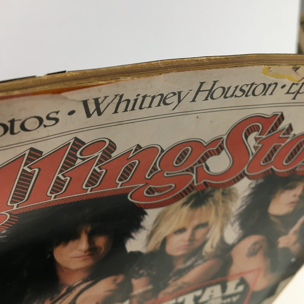 Close-up view of the August 13, 1987 Rolling Stone Magazine featuring Motley Crue and Whitney Houston, showcasing the iconic logo and artist names at the top. This collectible magazine captures the essence of '80s music culture.