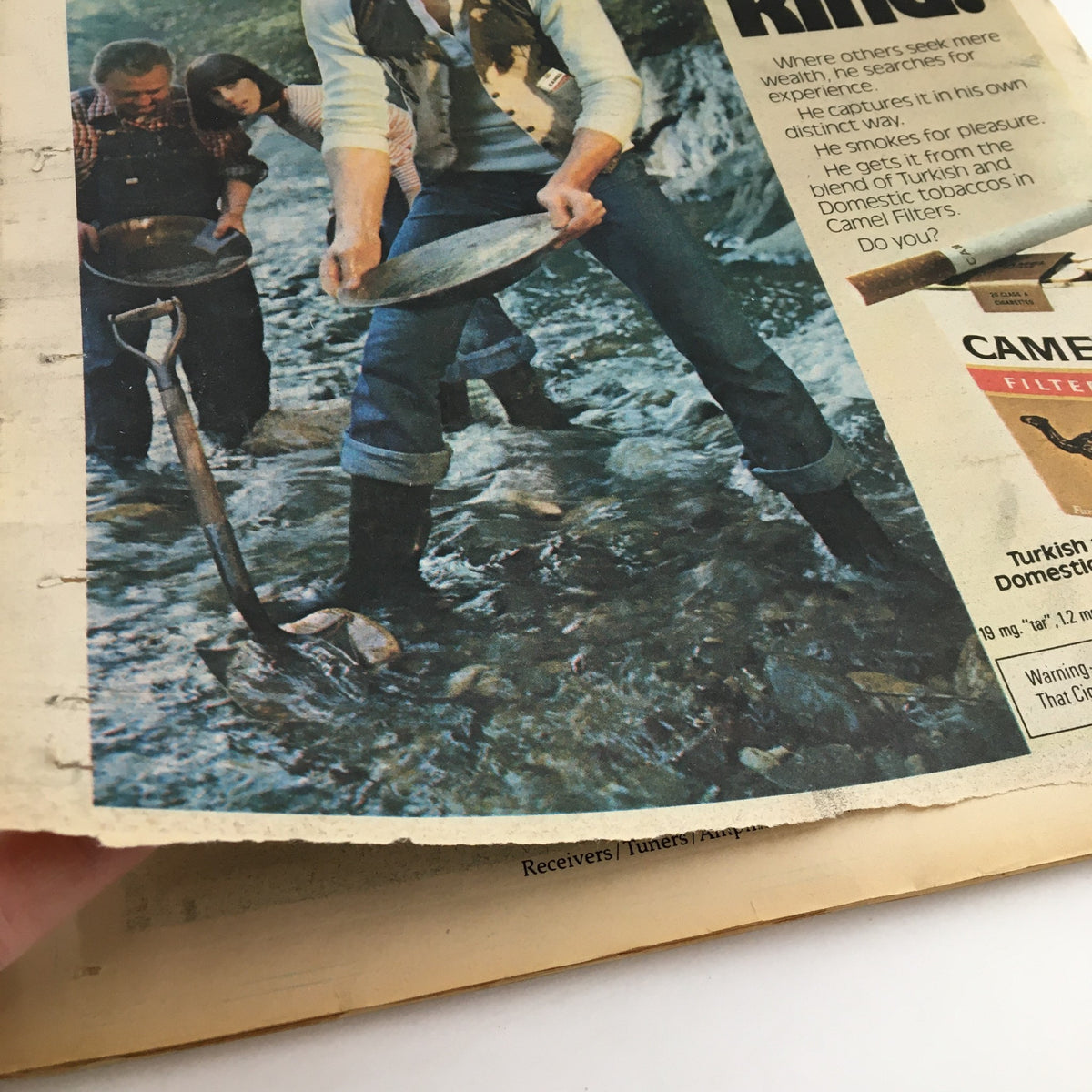 Inside page of Rolling Stone Magazine from September 8, 1977 showcasing a vintage advertisement with individuals panning for gold, reflecting the era's leisure activities.