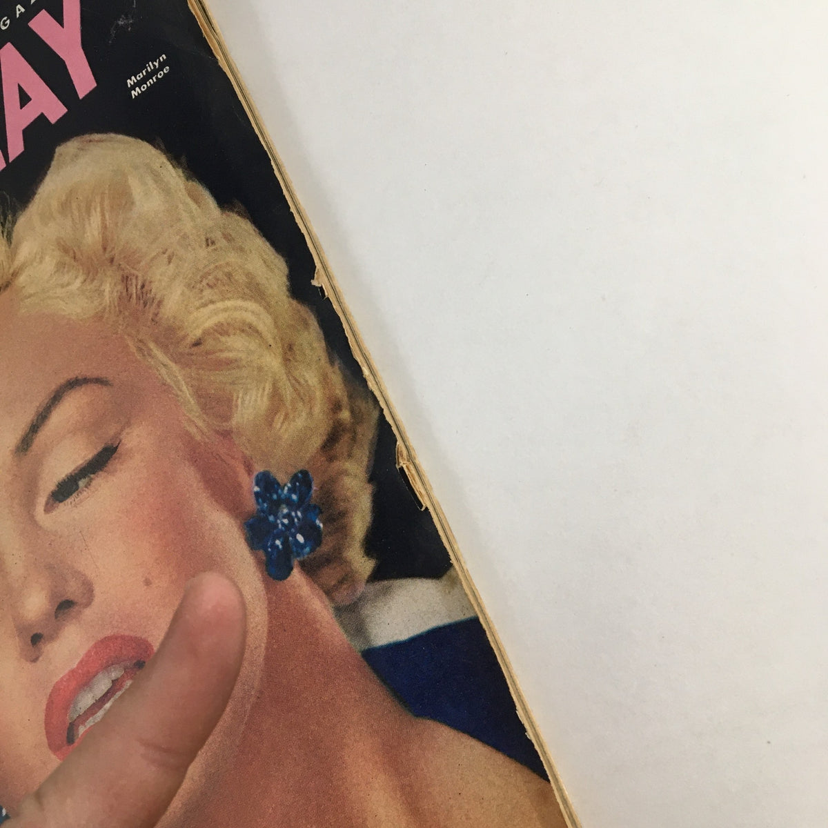 Cover of Photoplay Magazine February 1953 featuring Marilyn Monroe with stylish blonde hair and blue flower earrings, showcasing the glamour of Hollywood.