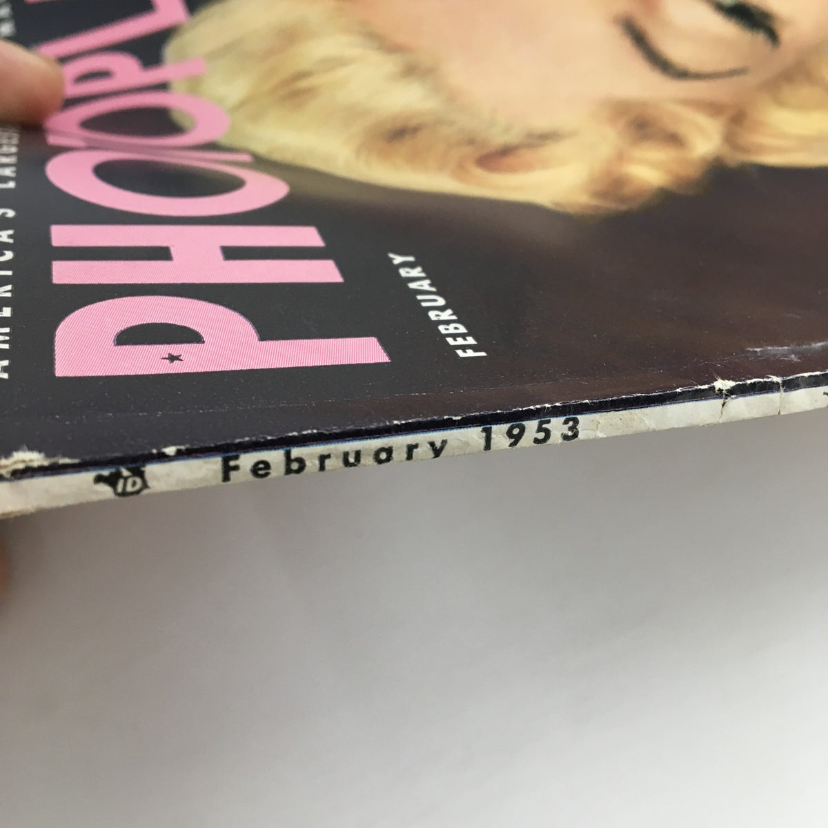 Spine detail of the February 1953 Photoplay Magazine, highlighting its publication date and wear, reflecting its history.