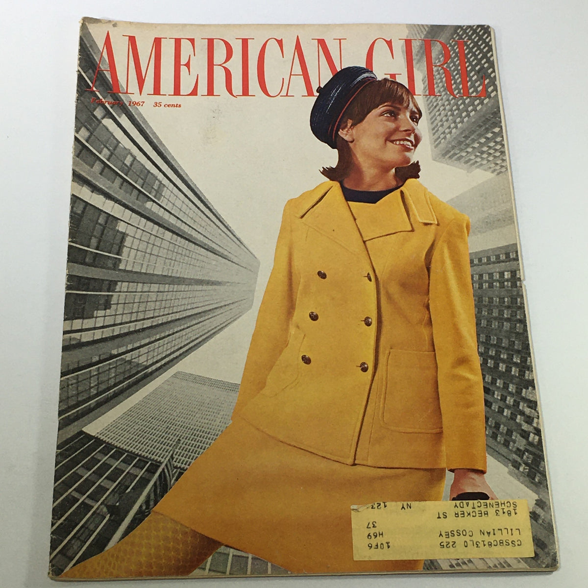 VTG American Girl Magazine February 1967 featuring Jonni on the cover, showcasing a young woman in a stylish yellow coat against a backdrop of modern skyscrapers.
