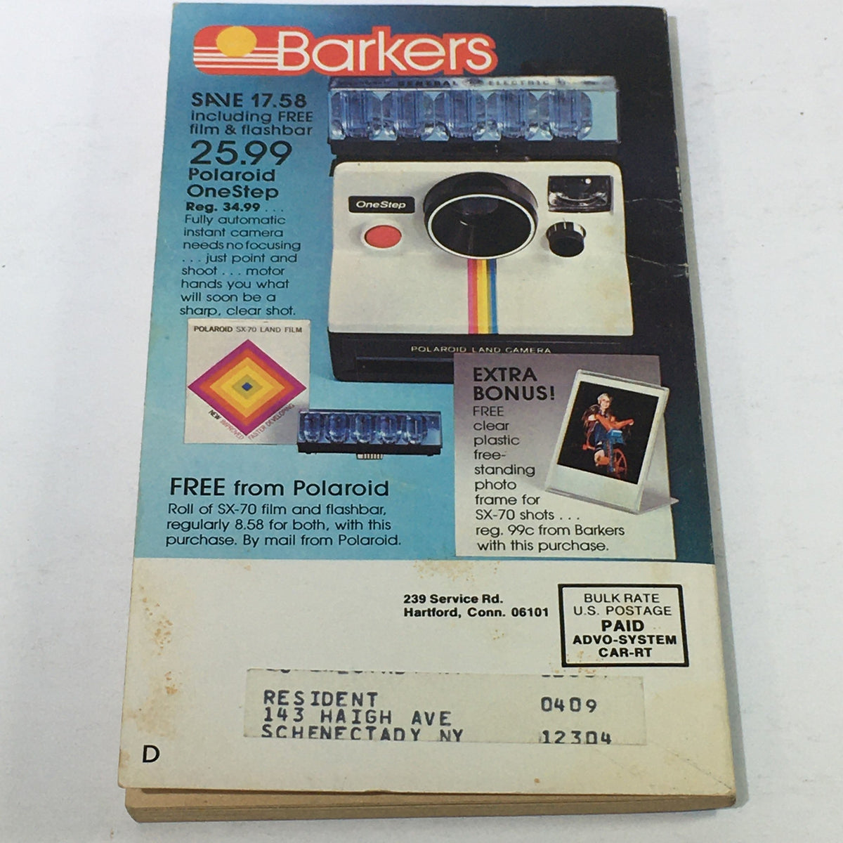 Vintage Barkers Lowest Price Guide Catalog featuring a Polaroid OneStep camera advertisement from the 1970s. The image displays information about a promotional offer, including free film and flashbar, along with contact details and additional bonuses.