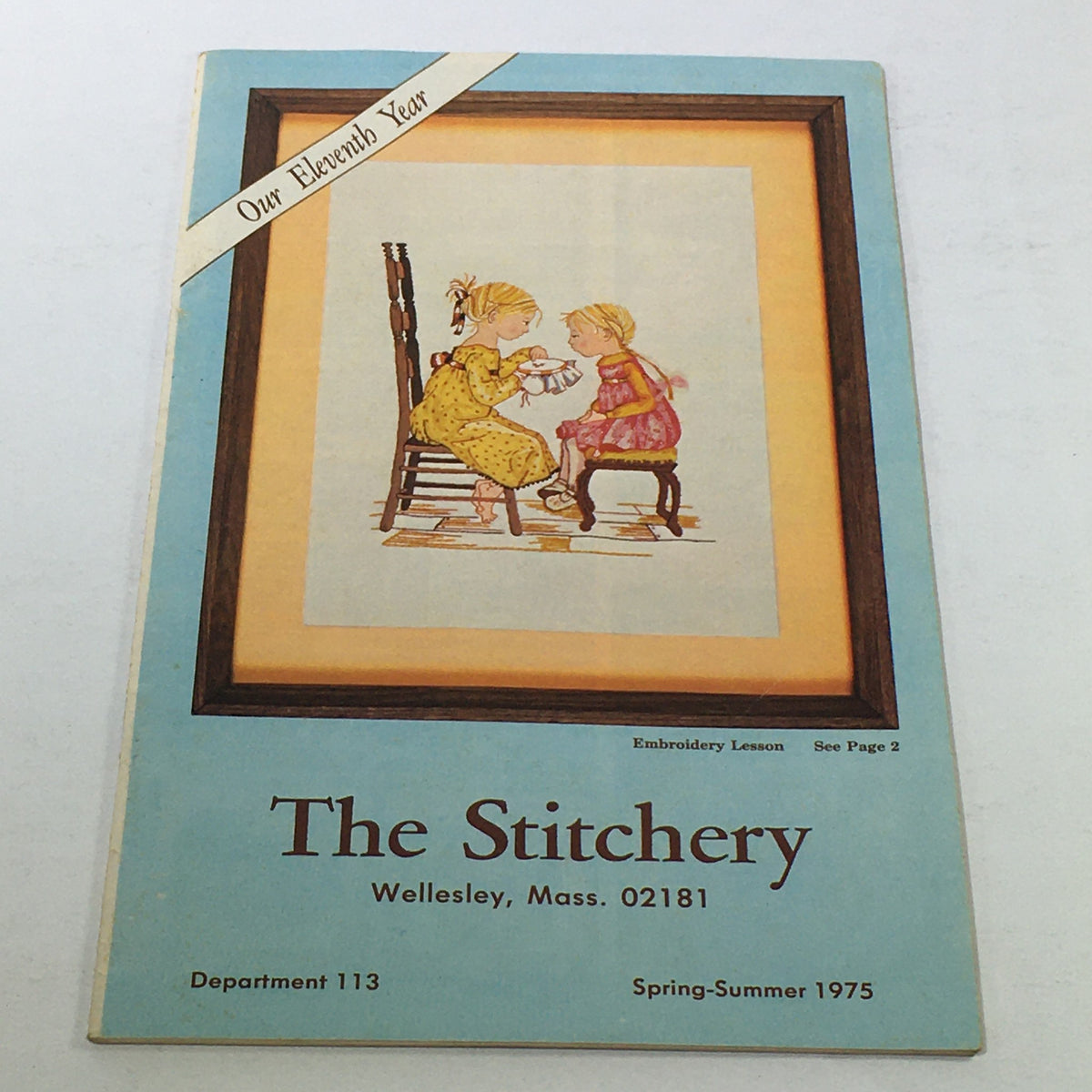 VTG Rare The Stitchery 11th Year Price Guide Catalog Spring-Summer 1975 cover featuring two children engaged in embroidery lessons.