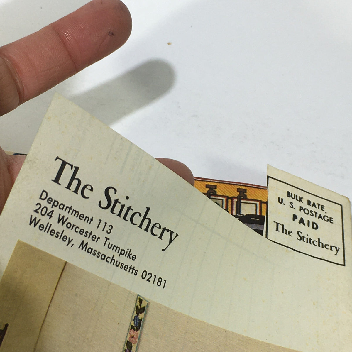 Close-up of the address section on the back of the VTG Rare The Stitchery 11th Year Price Guide Catalog, highlighting its historical significance from 1975.