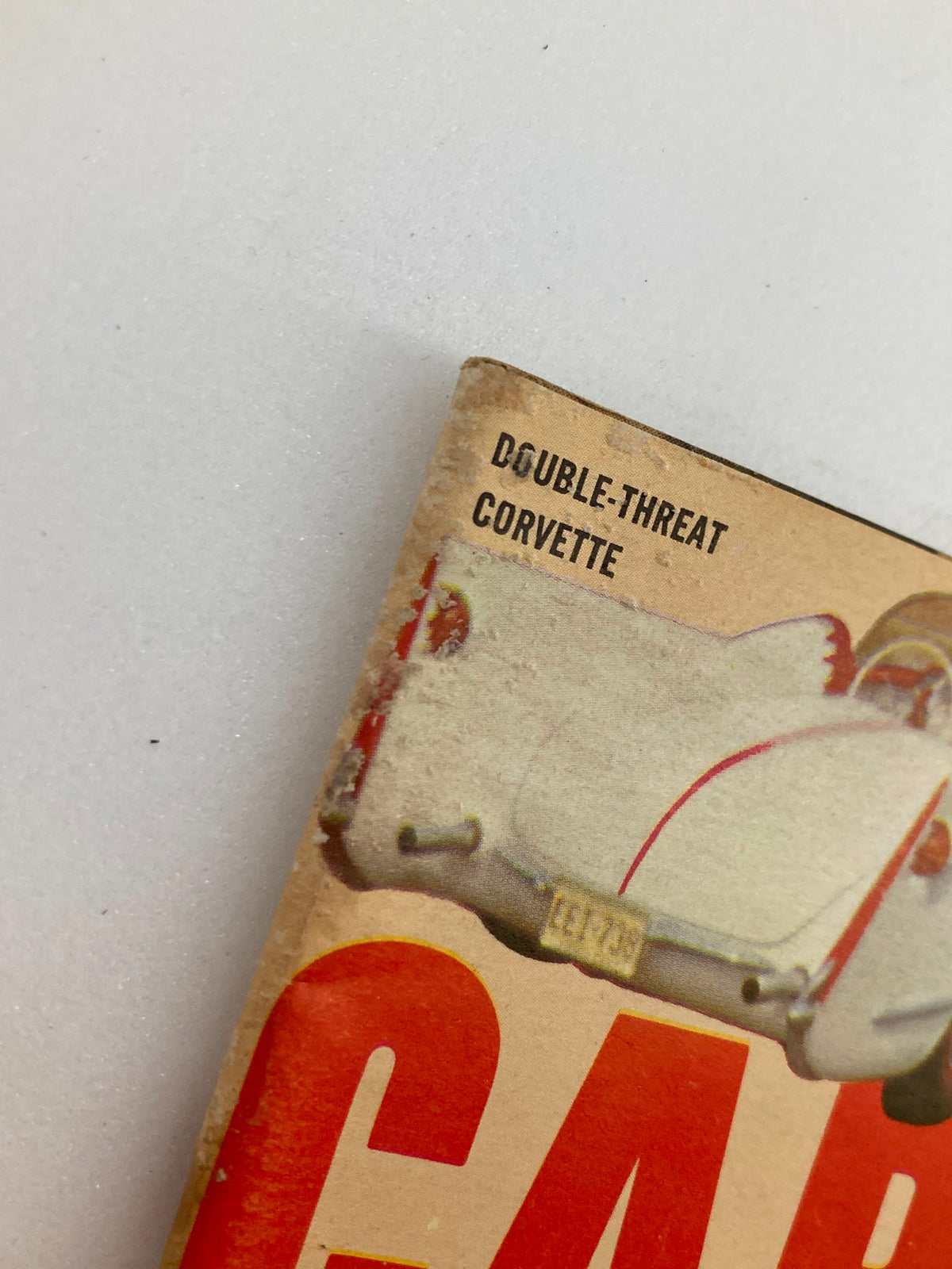 Close-up of the spine of VTG Car Speed & Style Magazine February 1961 displaying the words DOUBLE-THREAT CORVETTE, highlighting the unique features of the vintage publication.