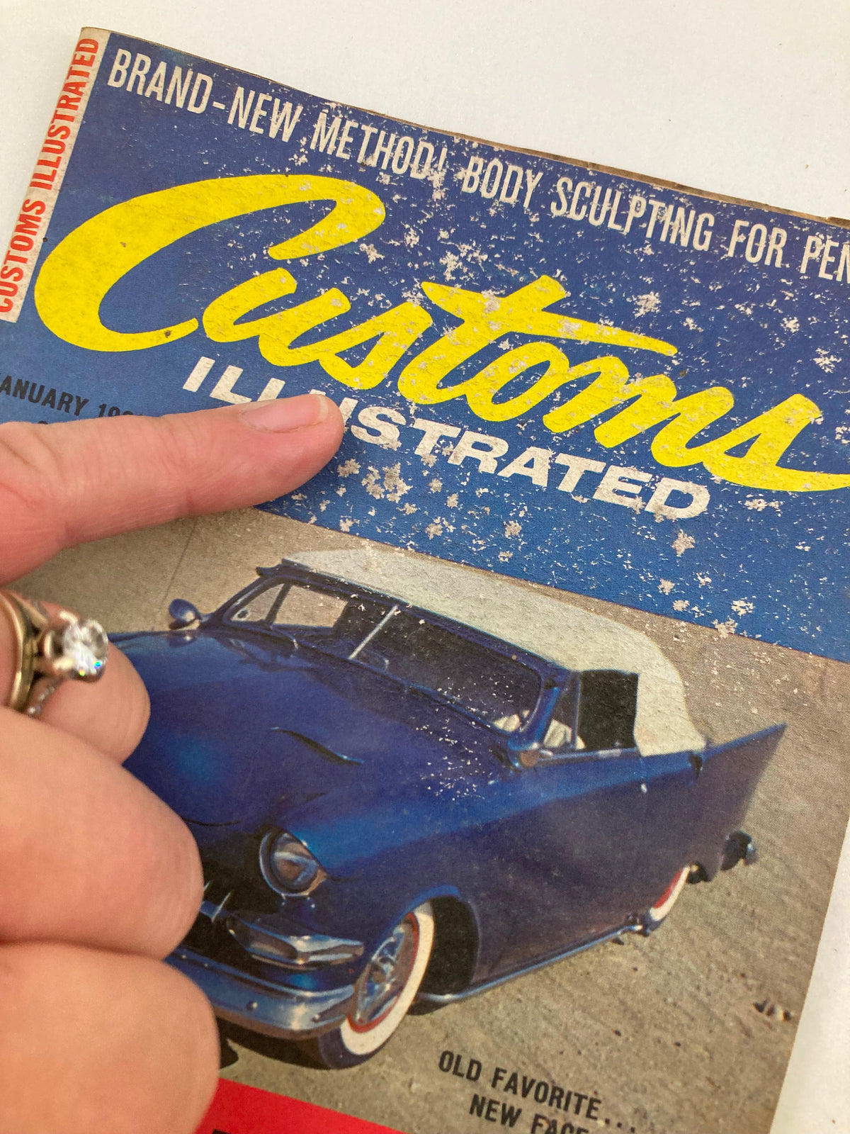 Cover of VTG Customs Illustrated Magazine January 1961 Vol 3 #6, featuring a blue classic car with hand pointing to the title, showcasing vintage automotive culture.