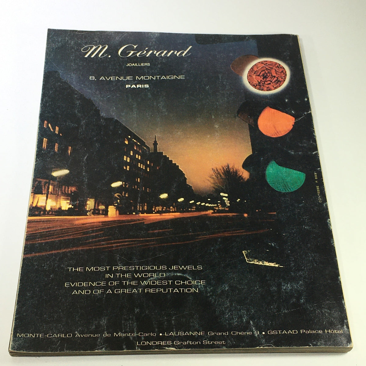 L'Officiel USA Magazine Fall Collection 1976 showcasing the cover of M. Gérard Joalliers, featuring elegant jewelry and a nighttime Paris cityscape.