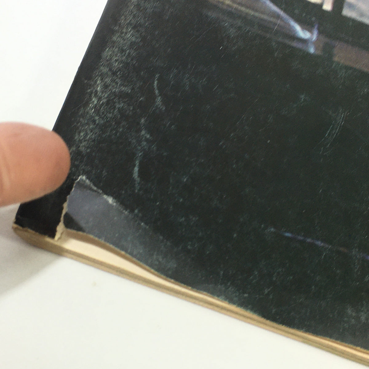 Close-up image of the damaged corner of the November 1969 issue of VTG Gourmet: The Magazine of Good Living, displaying wear and tear on the cover.