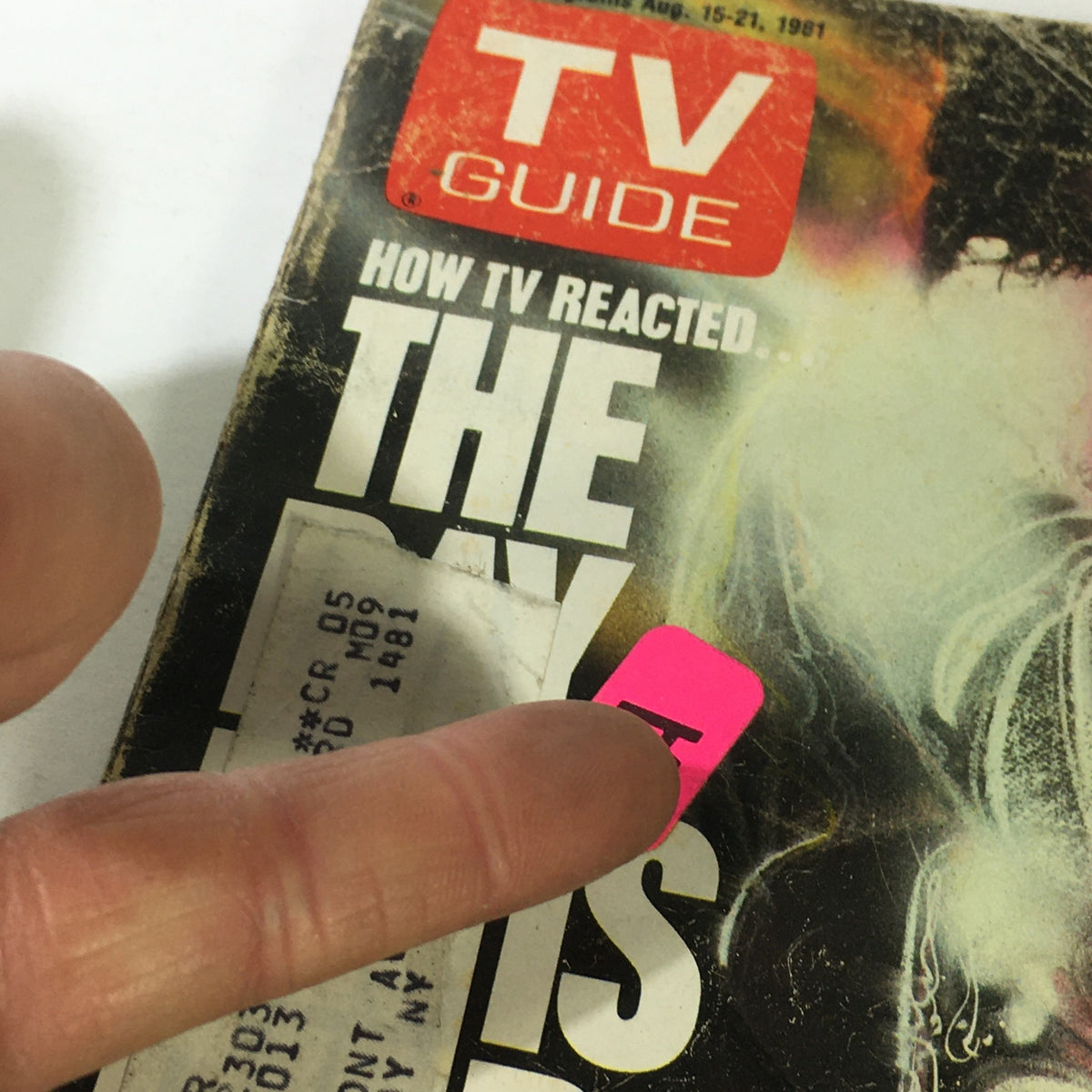 Close-up of the VTG TV Guide Local Programs August 15-21 1981 cover, emphasizing the title 'The Day Elvis Died' with a finger pointing at a label, highlighting its vintage appeal and condition.